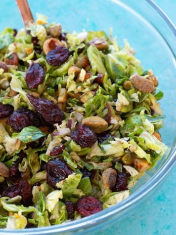 This Shaved Brussels Sprouts Salad is the best no-cook, meal prep dish! This healthy, easy salad is perfect for lunch, potlucks, holiday parties, and more!