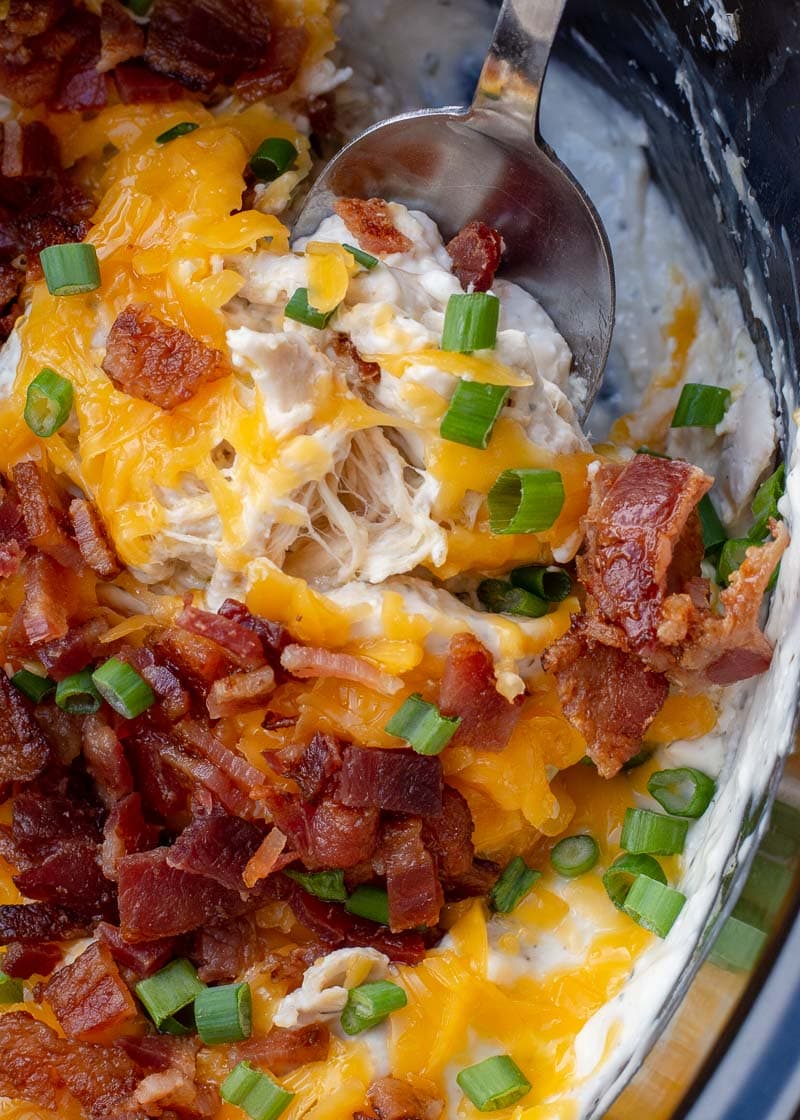 This easy Crockpot Crack Chicken requires just six ingredients and is always a hit at parties! This easy chicken recipe is loaded with ranch, bacon and cheese, making it perfect for salads, wraps, sandwiches and more! 