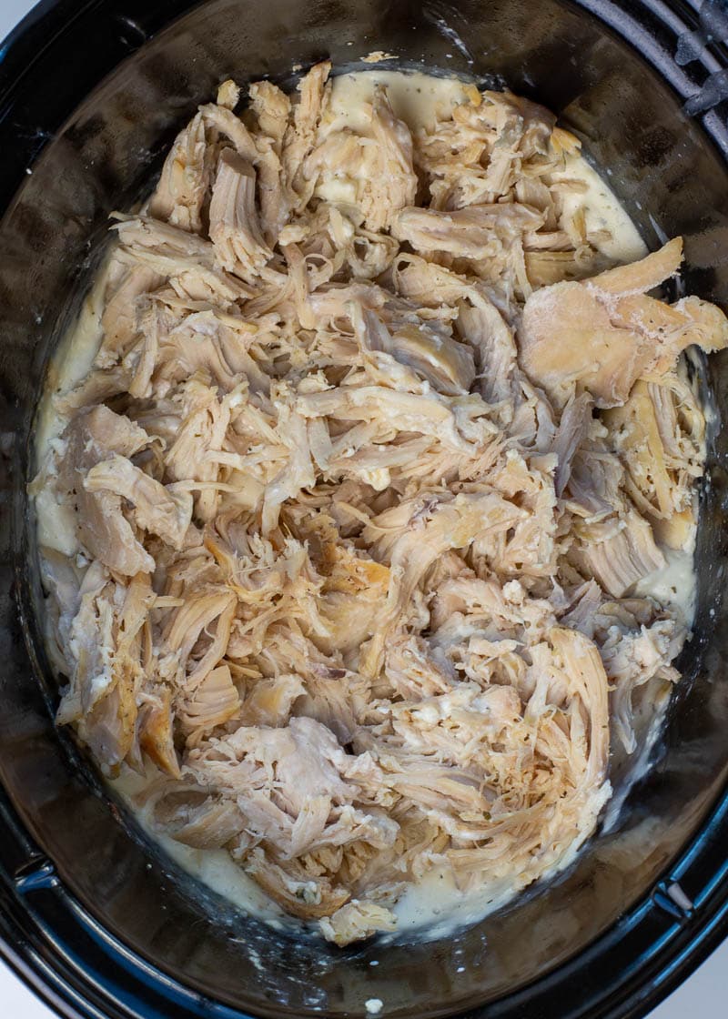 This easy Crockpot Crack Chicken requires just six ingredients and is always a hit at parties! This easy chicken recipe is loaded with ranch, bacon and cheese, making it perfect for salads, wraps, sandwiches and more! 