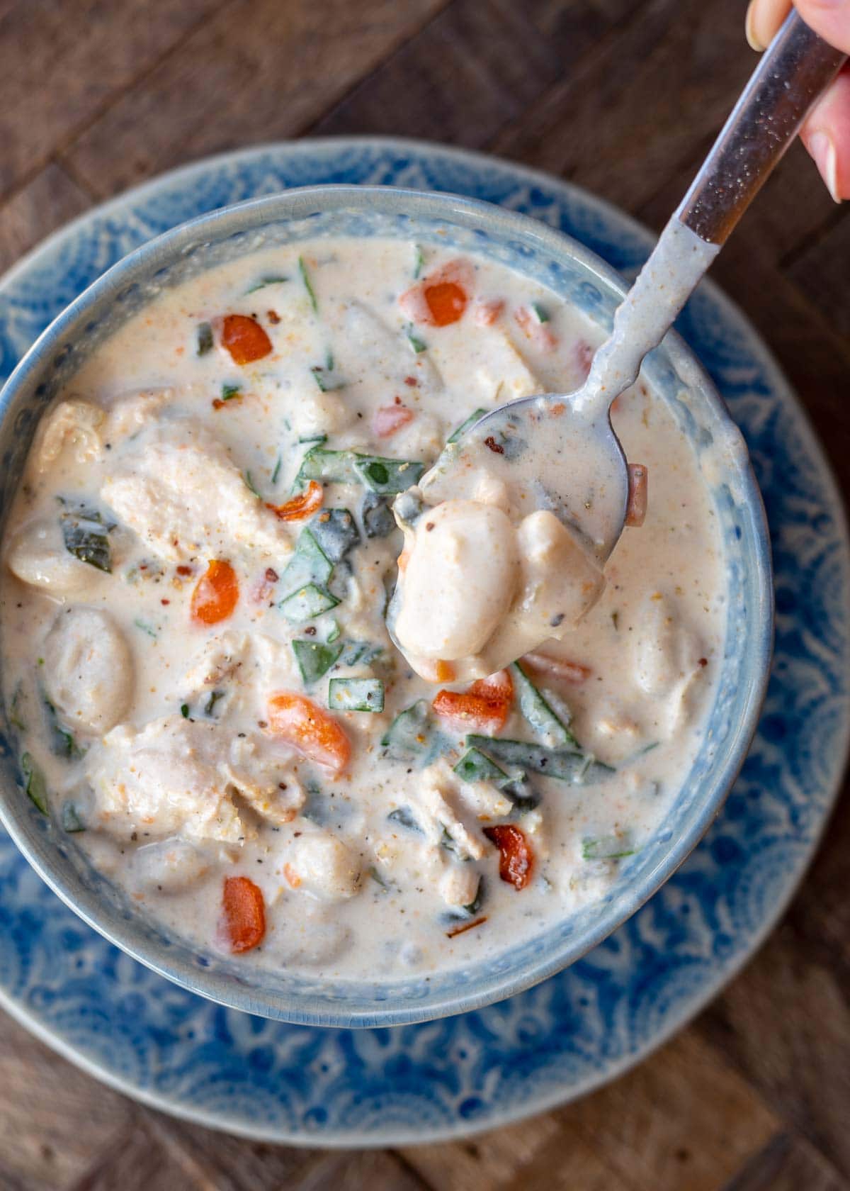This creamy Chicken Gnocchi Soup recipe is the perfect comfort food! Tender chicken is paired with vegetables and gnocchi for a hearty, healthy meal!