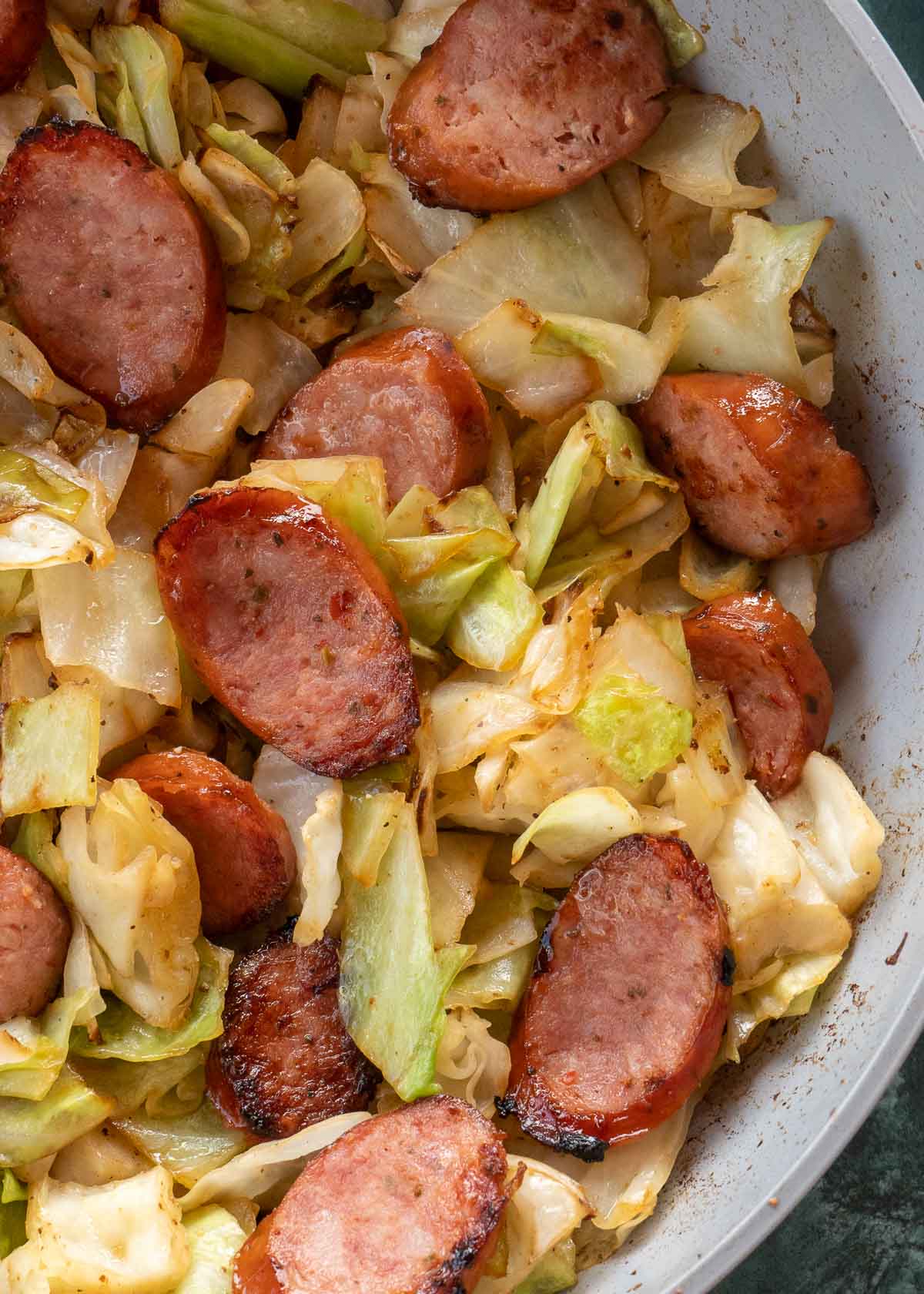 Need an easy low carb, one-pan dinner? I've got you covered! This Keto Sausage and Cabbage Skillet is ready in under 20 minutes and has less than 6 carbs per serving!