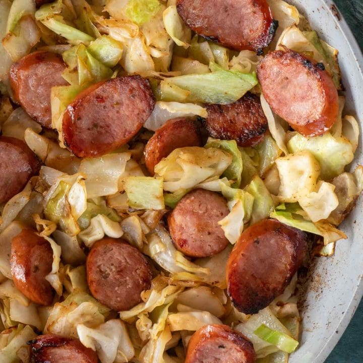 Need an easy low carb, one-pan dinner? I've got you covered! This Keto Sausage and Cabbage Skillet is ready in under 20 minutes and has less than 6 carbs per serving!