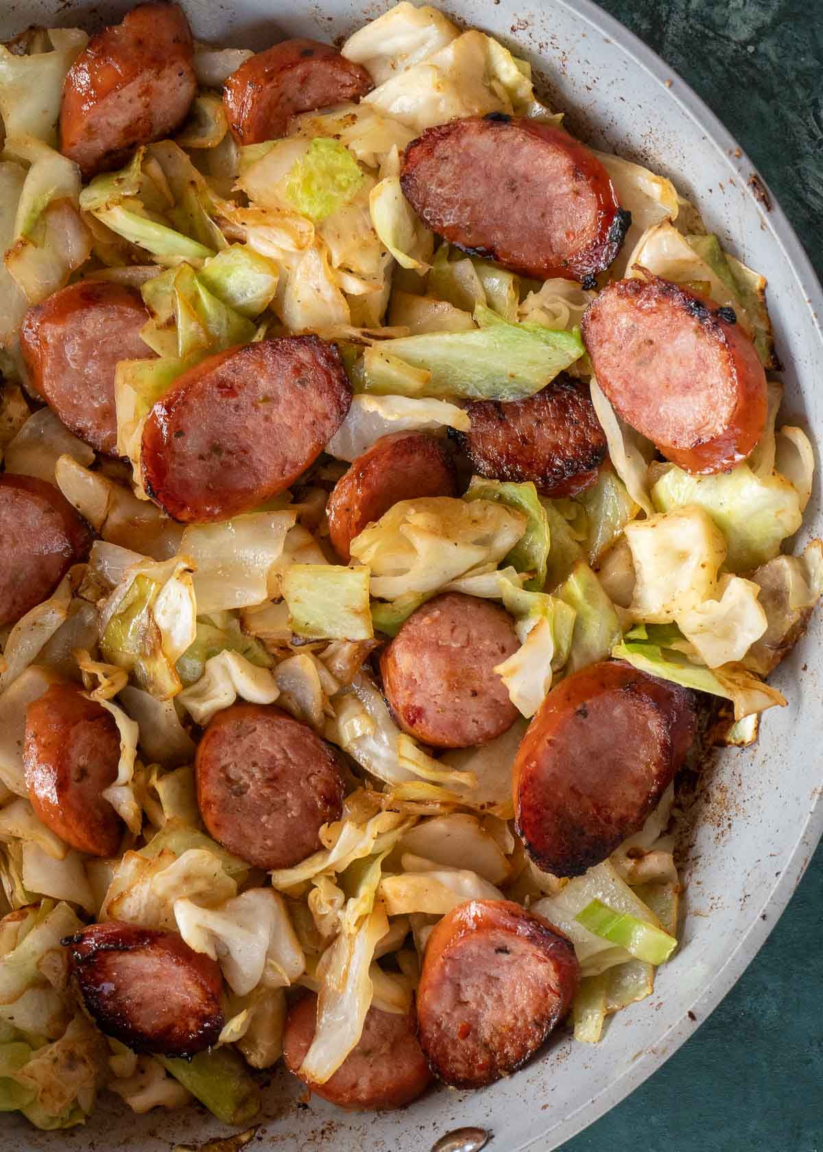 Need an easy low carb, one-pan dinner? I've got you covered! This Keto Sausage and Cabbage Skillet is ready in under 20 minutes and has less than 6 carbs per serving!