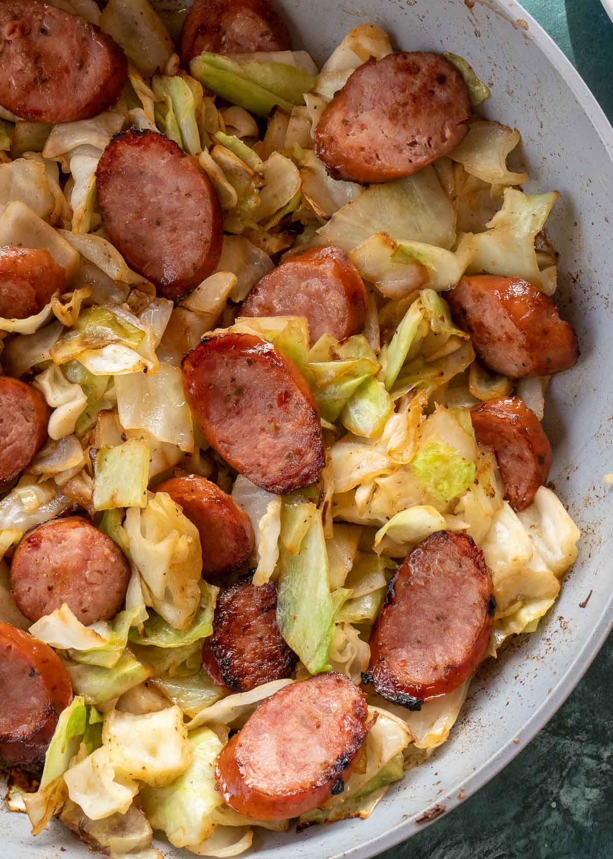 Need an easy low carb, one-pan dinner? I've got you covered! This Keto Sausage and Cabbage Skillet is ready in under 20 minutes and has less than 6 carbs per serving!