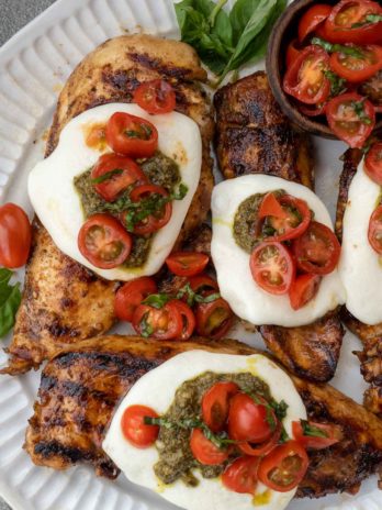 This Chicken Margherita recipe is full of fresh flavors! Balsamic Grilled Chicken is topped with fresh mozzarella, creamy pesto, and a bright tomato basil salad!