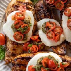 This Chicken Margherita recipe is full of fresh flavors! Balsamic Grilled Chicken is topped with fresh mozzarella, creamy pesto, and a bright tomato basil salad!