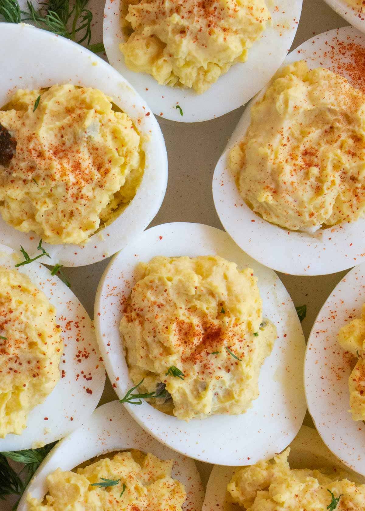 deviled eggs with paprika on white plate