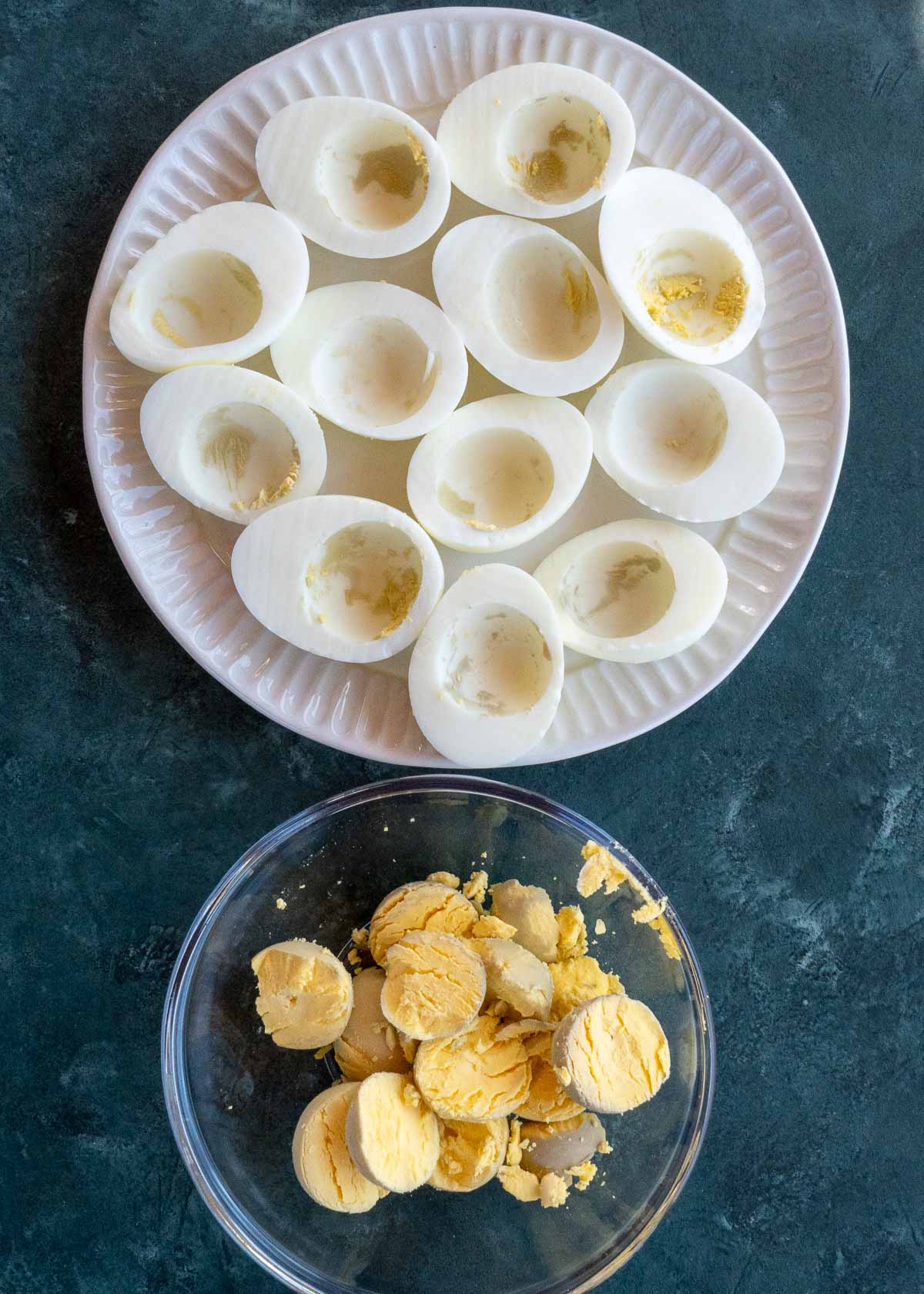 egg white on a plate and egg yolks in a bowl