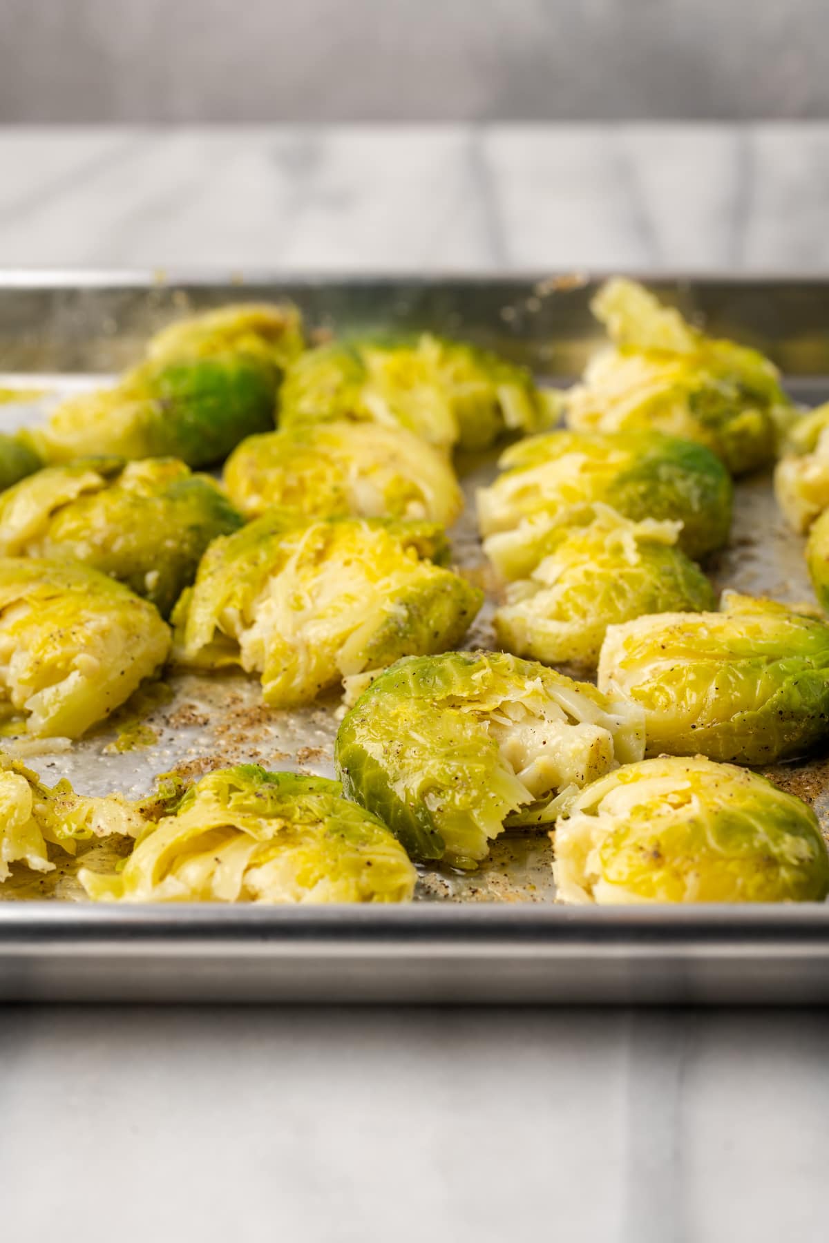 Smashed Brussels sprouts on sheet pan before baking