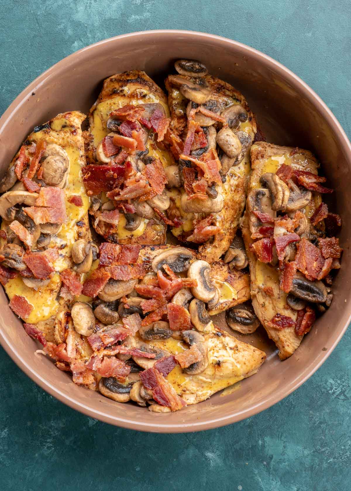 bacon covered chicken in baking dish