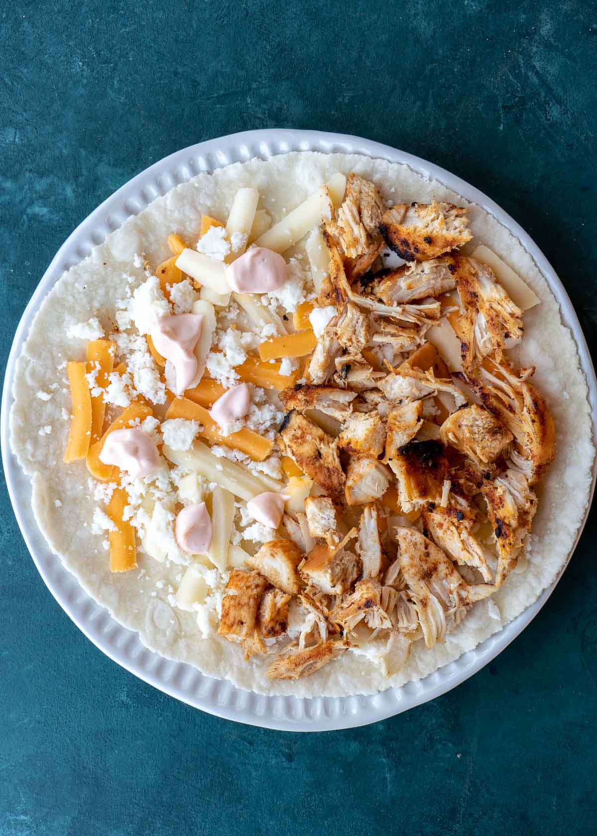 Learn how to make the best Chicken Quesadilla! This easy chicken recipe features a crispy tortilla loaded with two kinds of cheese, tender chicken, and a savory sauce. 