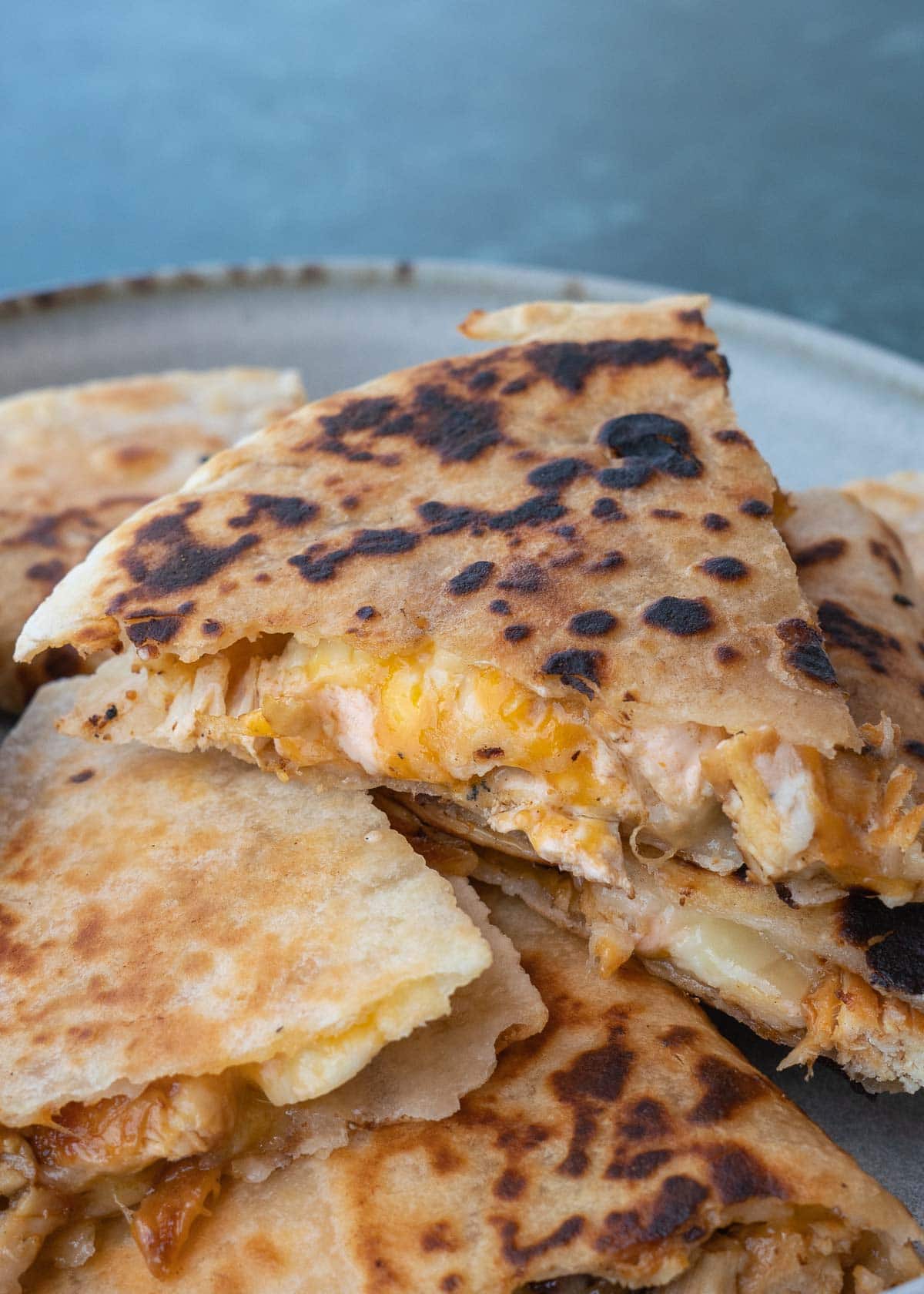 Learn how to make the best Chicken Quesadilla! This easy chicken recipe features a crispy tortilla loaded with two kinds of cheese, tender chicken, and a savory sauce. 