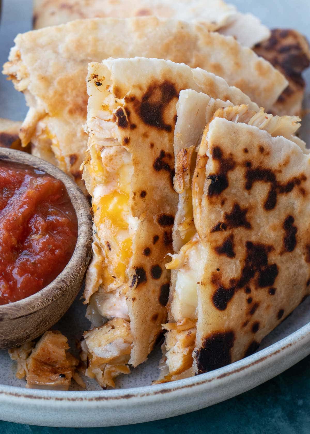 Learn how to make the best Chicken Quesadilla! This easy chicken recipe features a crispy tortilla loaded with two kinds of cheese, tender chicken, and a savory sauce. 