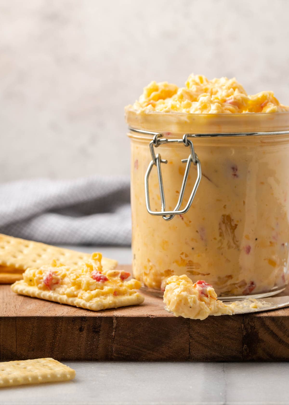 Pimento Cheese and crackers on a wooden cutting board.