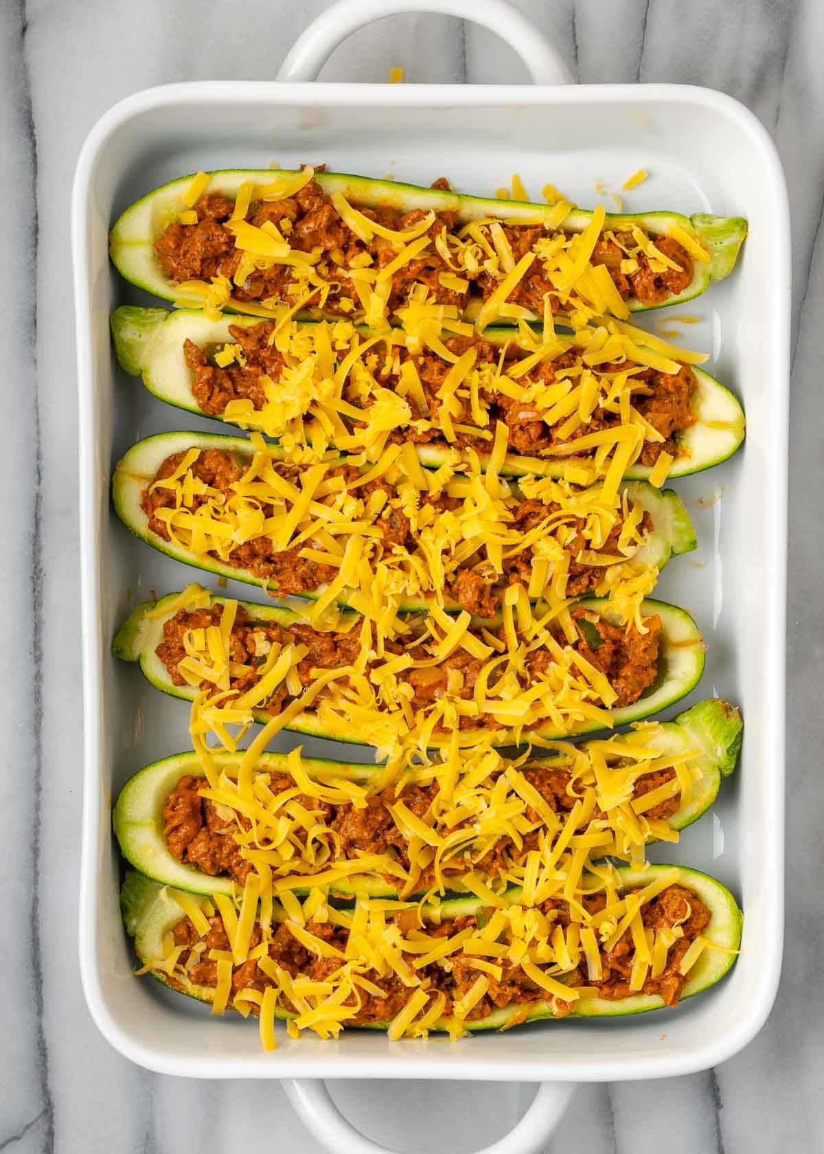 taco meat and cheese in zucchini
