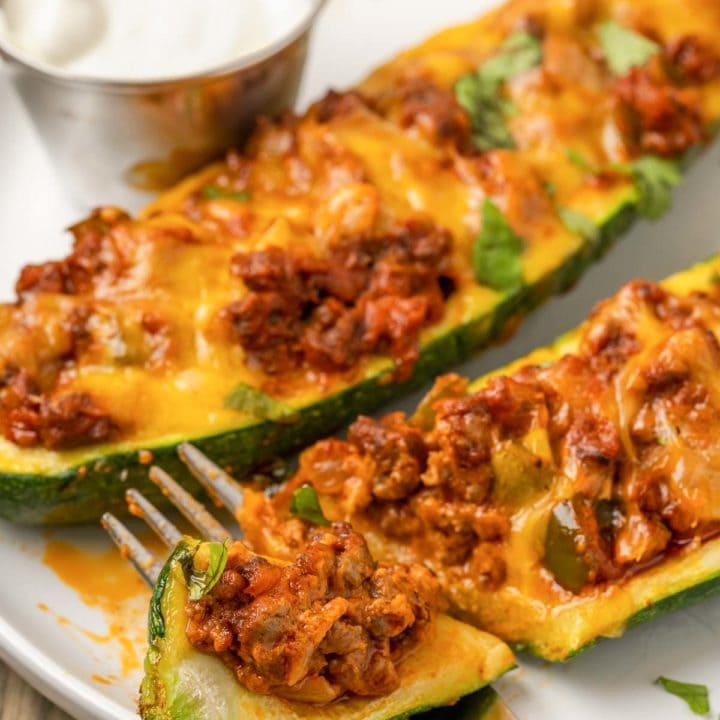 These Mexican Stuffed Zucchini Boats are full of seasoned ground beef, onions, peppers, and lots of melted cheddar cheese. They’re a guaranteed hit with the whole family! 