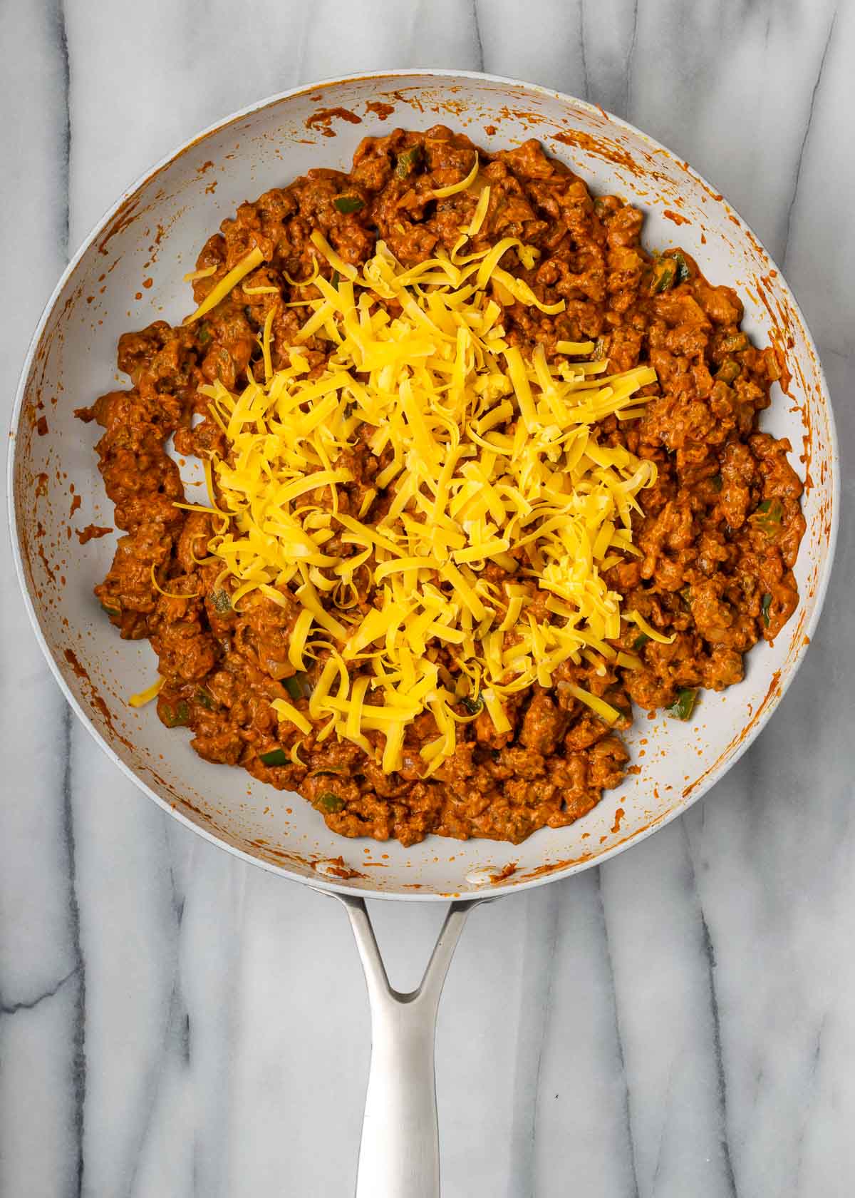 taco meat with cheese in skillet