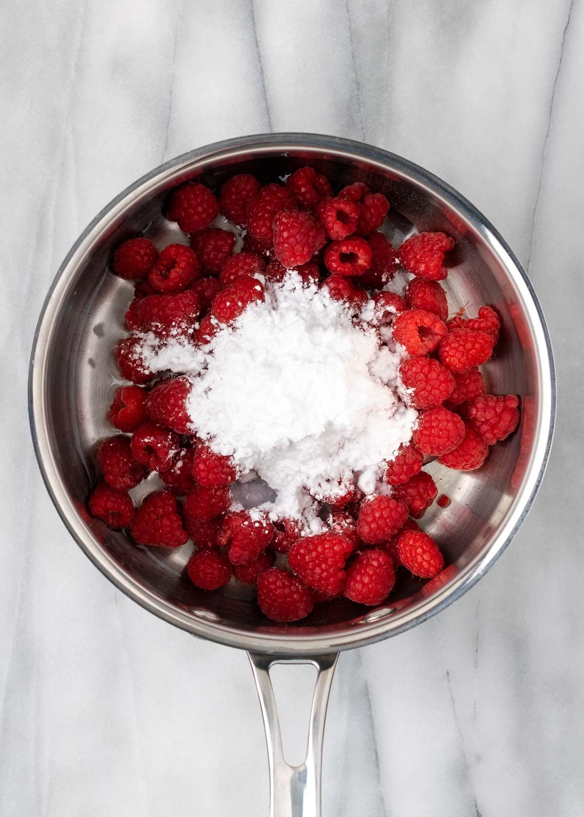 raspberries and sweetener in sauce pan