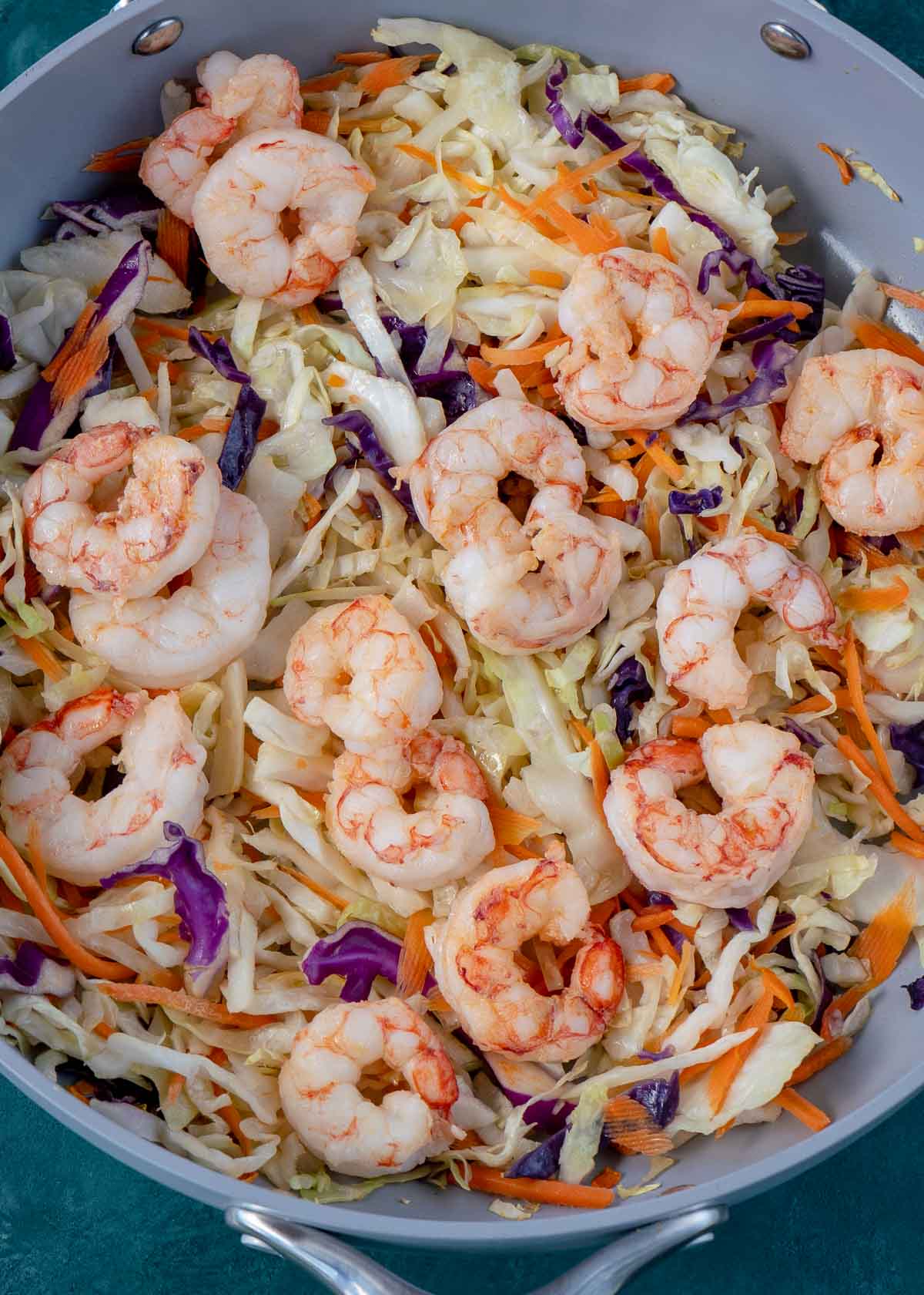 A pan full of carrots, cabbage, and shrimp