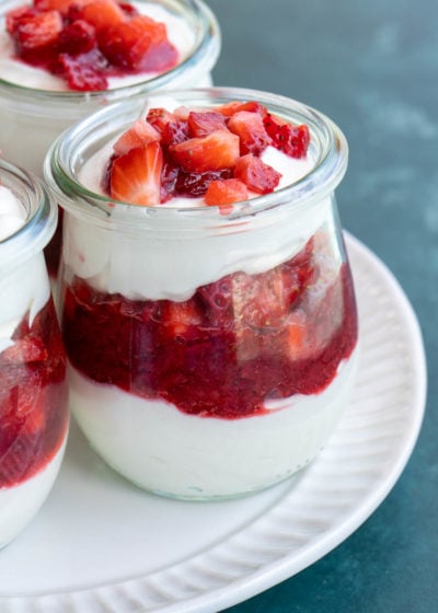 small jar with cheesecake and strawberry layers.