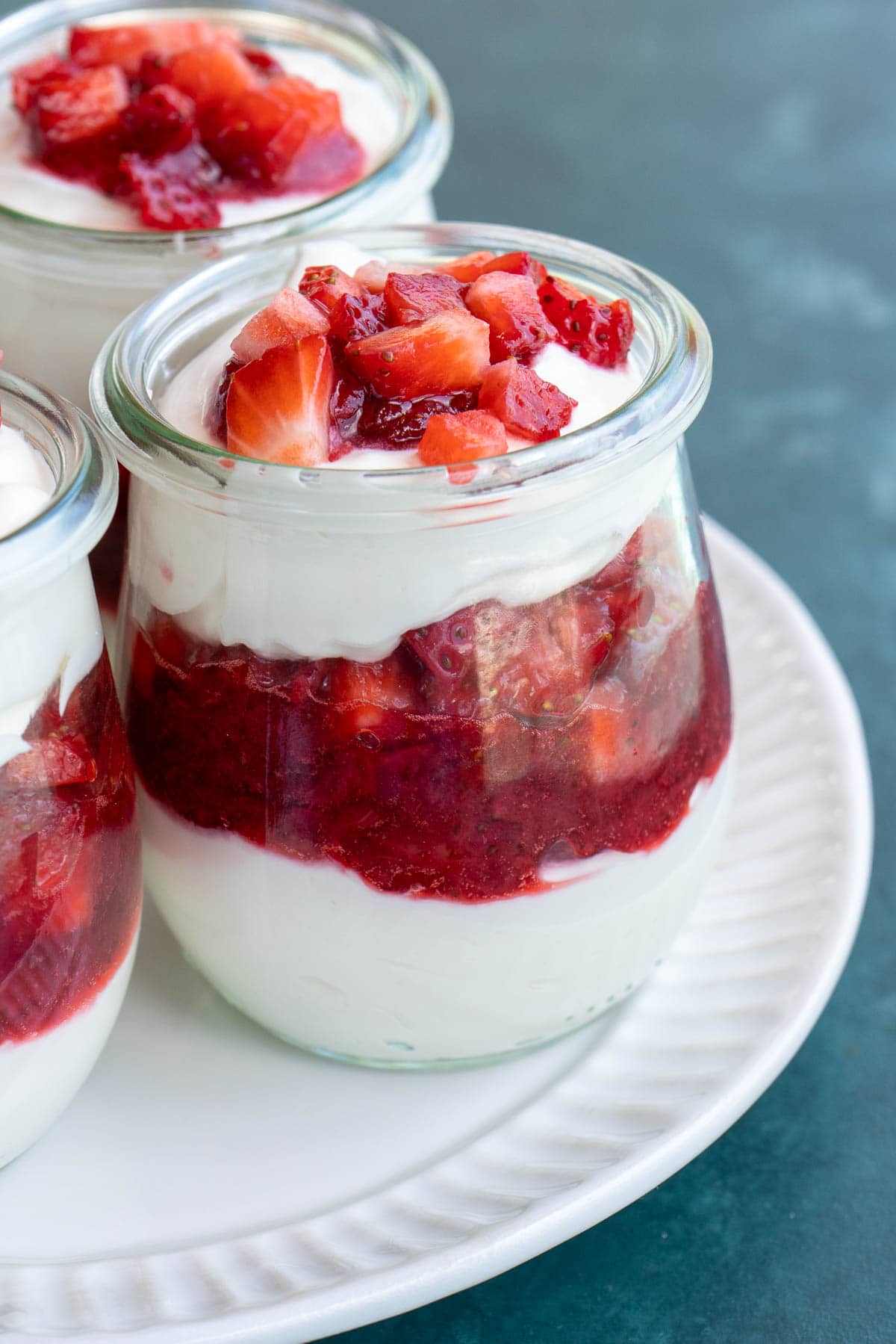 small jar with cheesecake and strawberry layers. 