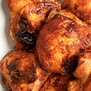 These Baked BBQ Chicken Thighs are easy enough for a weeknight! This smoky marinade keeps chicken super juicy and full of flavor.