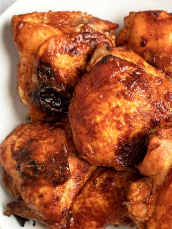 These Baked BBQ Chicken Thighs are easy enough for a weeknight! This smoky marinade keeps chicken super juicy and full of flavor.