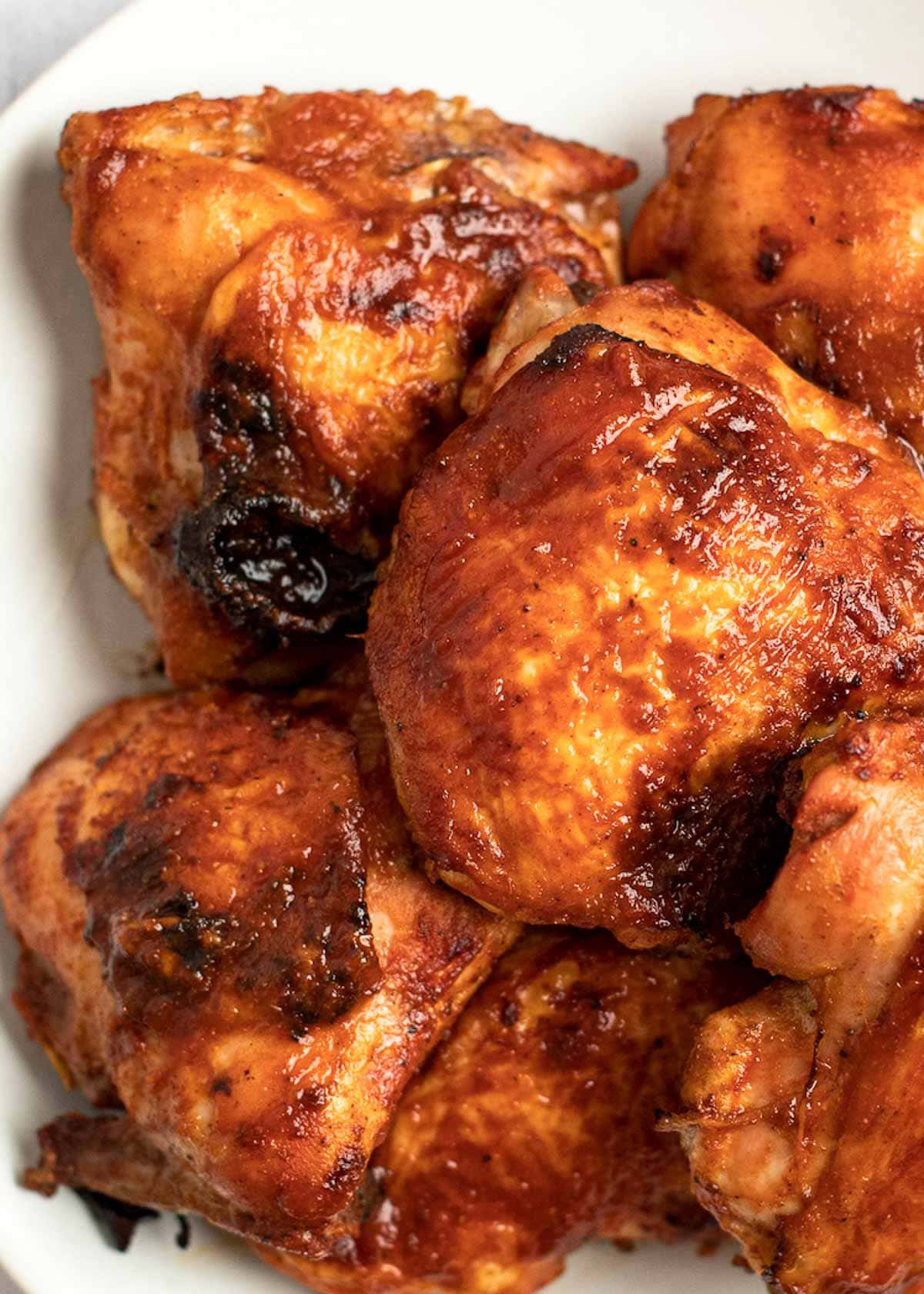 These Baked BBQ Chicken Thighs are easy enough for a weeknight! This smoky marinade keeps chicken super juicy and full of flavor.