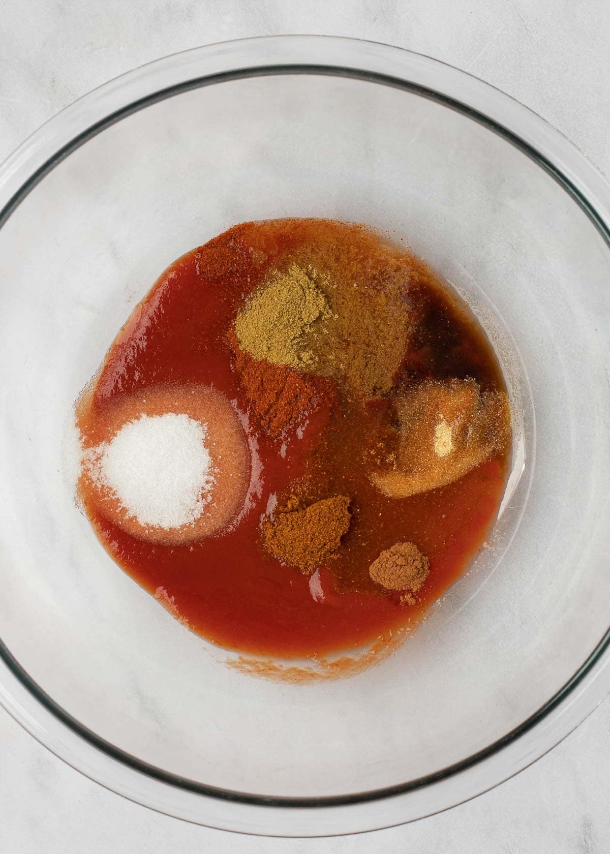 tomato juice, apple cider vinegar, lemon juice, and seasonings in a glass bowl