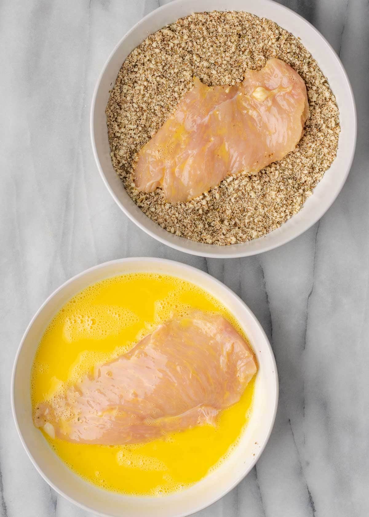 breading in bowl with chicken