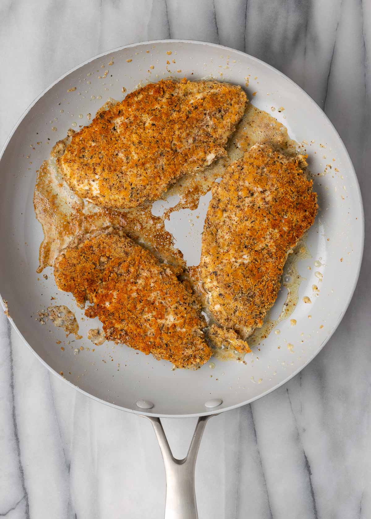 breaded chicken in skillet