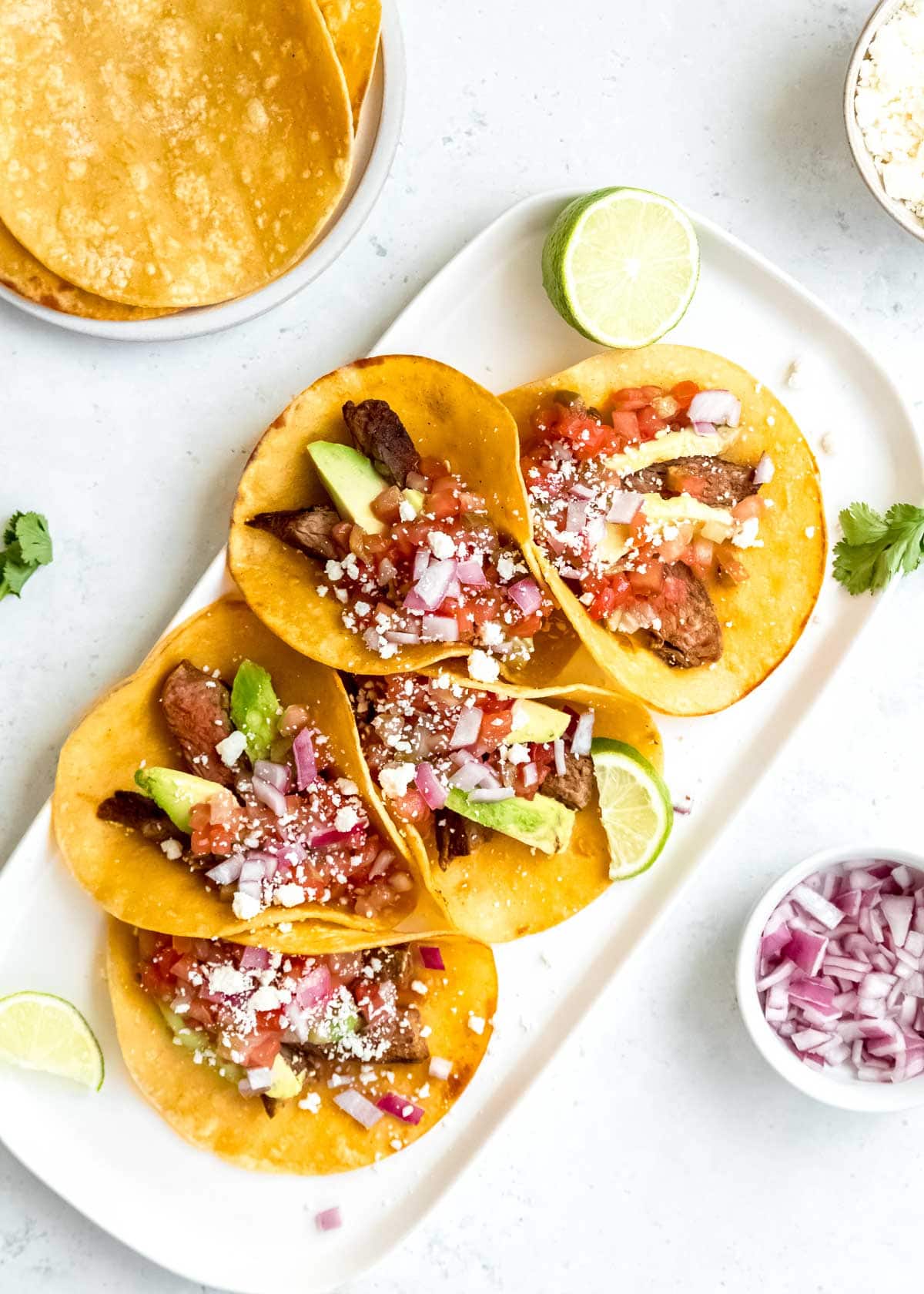 steak tacos on white cutting board