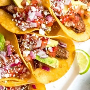 steak tacos on a white cutting board