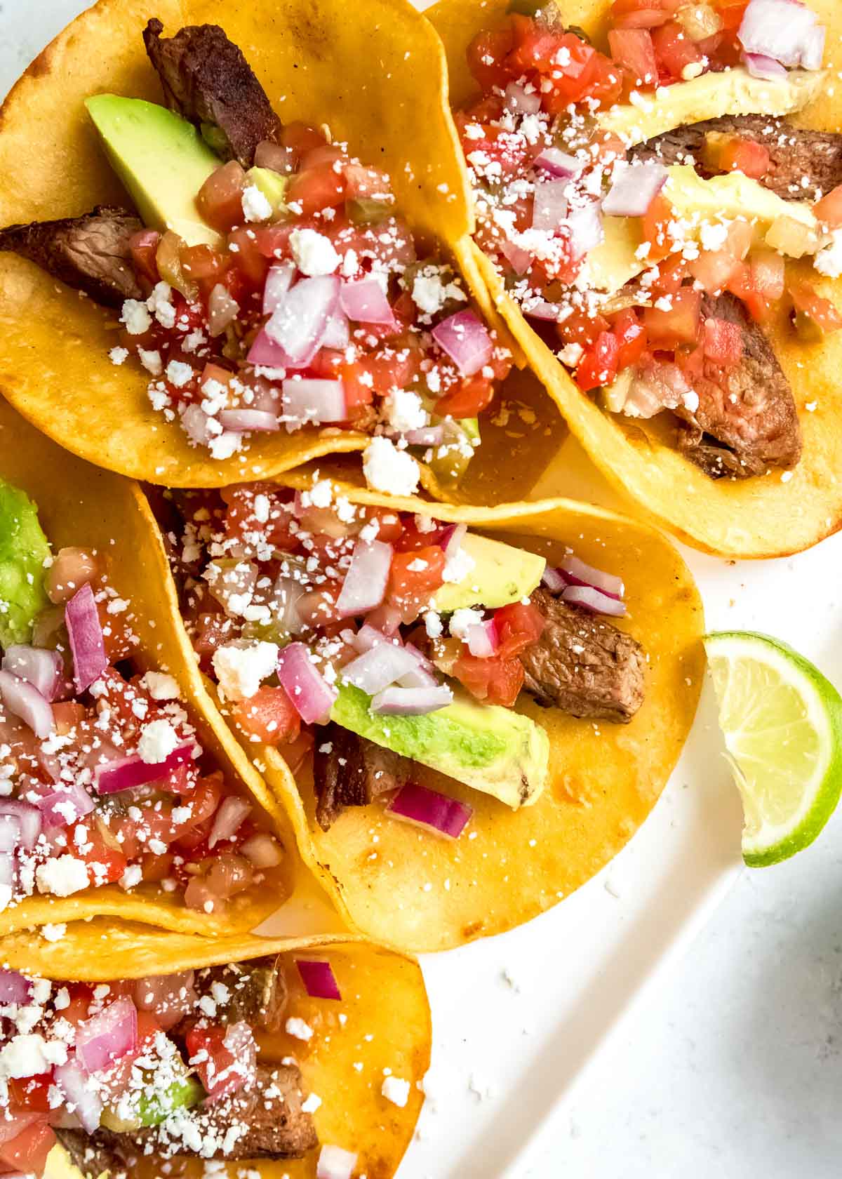 steak tacos on a white cutting board