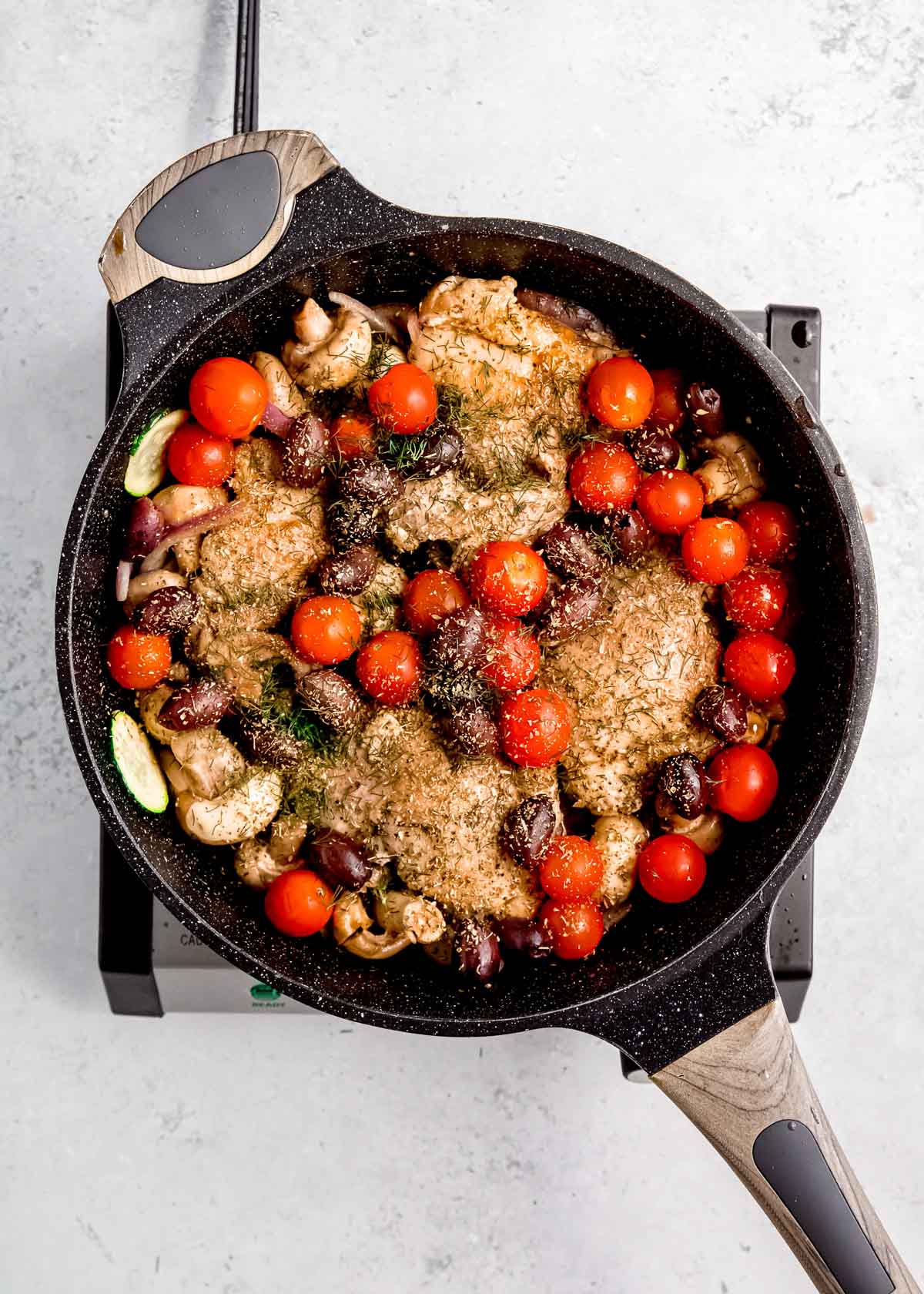 chicken, tomatoes, olives, veggies, balsamic vinegar, lemon juice, and broth in a skillet