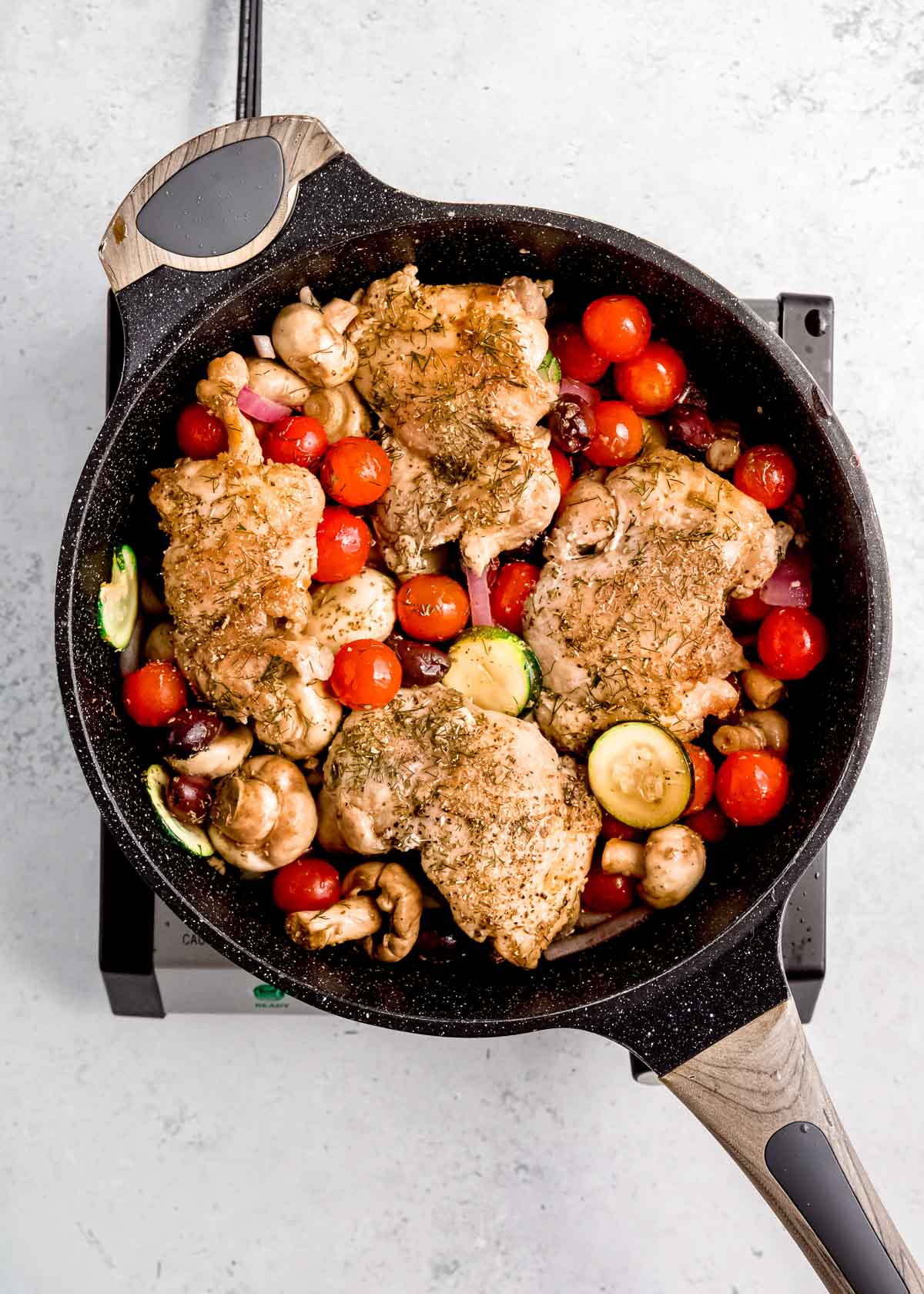 chicken, veggies, vinegar, broth, lemon juice in a skillet