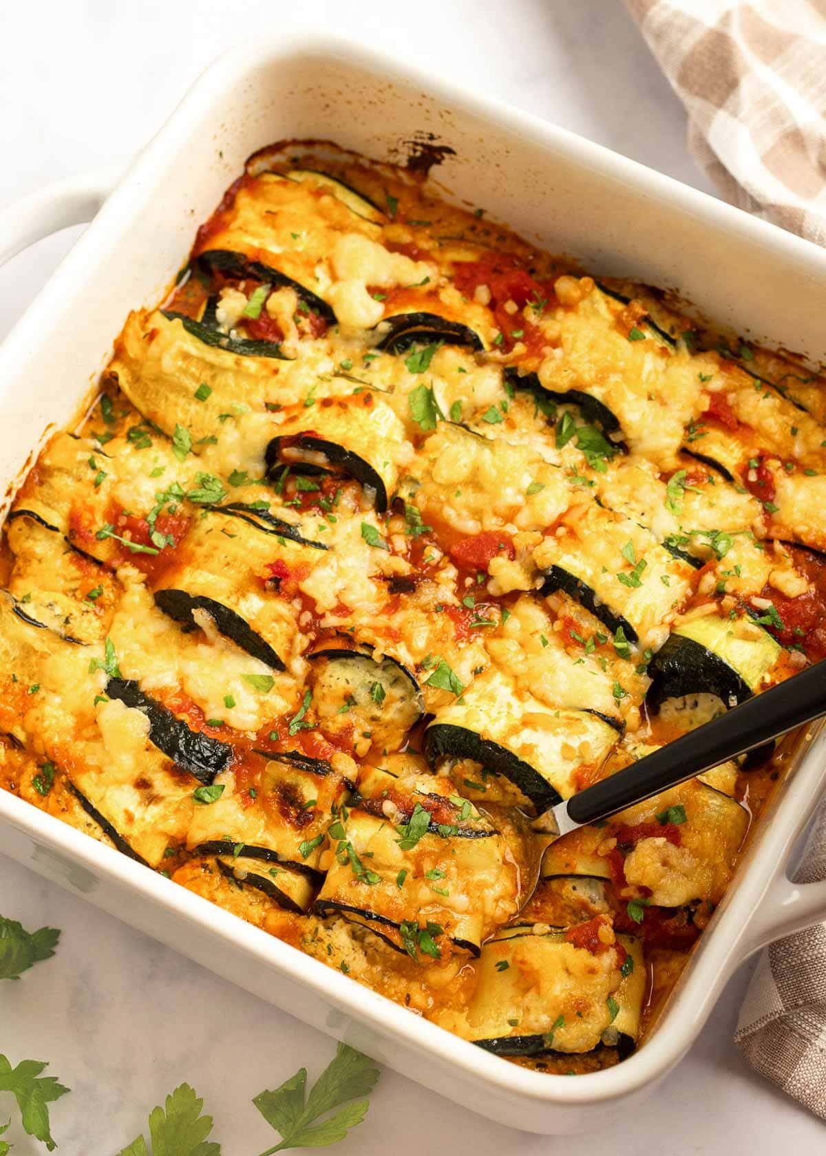 These delicious Zucchini Lasagna Rolls give you all your favorite flavors in a cheesy, creamy filling for less than 1 net carb each! This low-carb zucchini recipe is vegetarian, gluten-free, and perfect for a date night.