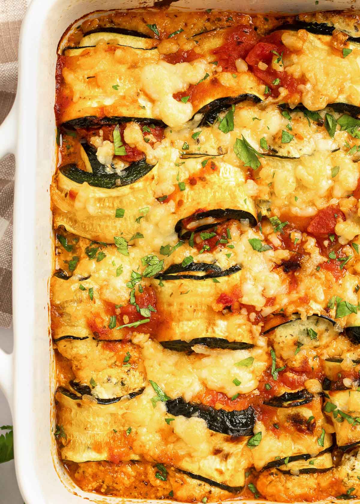 These delicious Zucchini Lasagna Rolls give you all your favorite flavors in a cheesy, creamy filling for less than 1 net carb each! This low-carb zucchini recipe is vegetarian, gluten-free, and perfect for a date night.