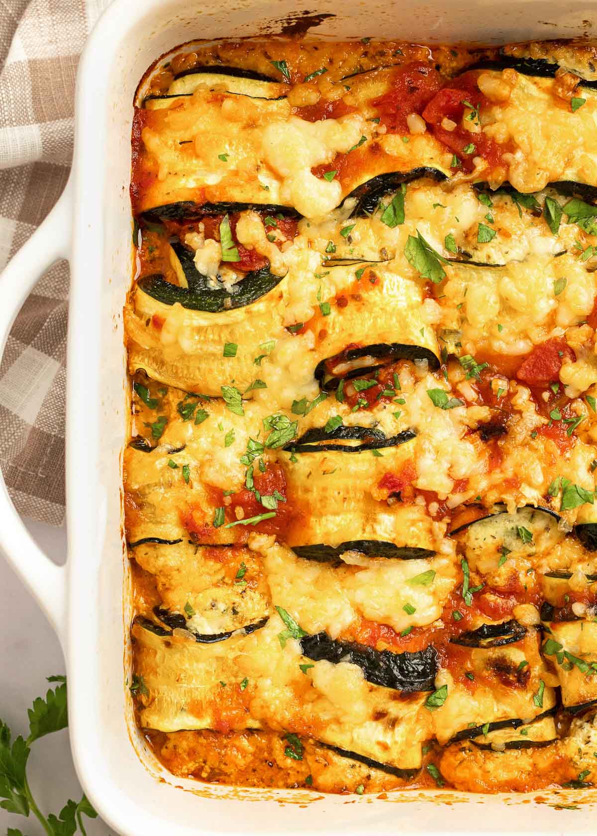 These delicious Zucchini Lasagna Rolls give you all your favorite flavors in a cheesy, creamy filling for less than 1 net carb each! This low-carb zucchini recipe is vegetarian, gluten-free, and perfect for a date night.