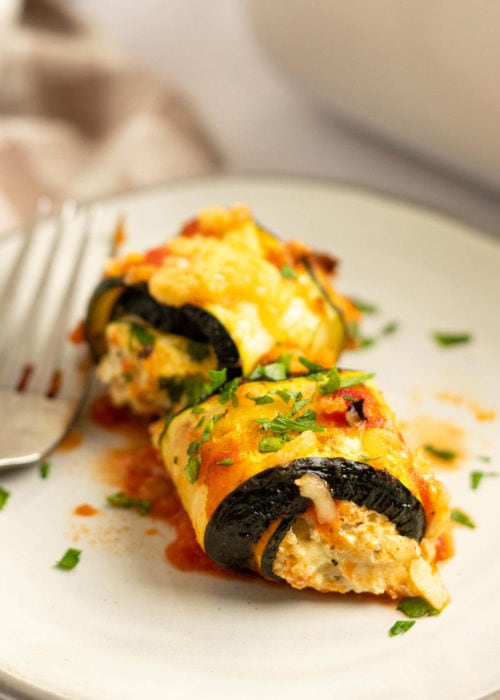 These delicious Zucchini Lasagna Rolls give you all your favorite flavors in a cheesy, creamy filling for less than 1 net carb each! This low-carb zucchini recipe is vegetarian, gluten-free, and perfect for a date night.