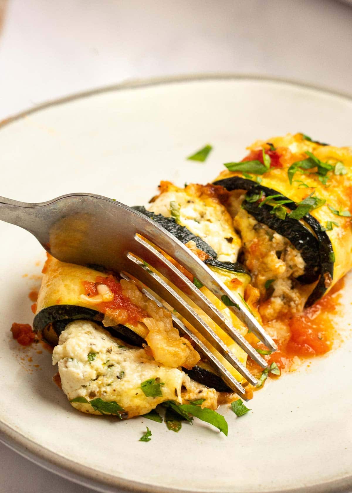 These delicious Zucchini Lasagna Rolls give you all your favorite flavors in a cheesy, creamy filling for less than 1 net carb each! This low-carb zucchini recipe is vegetarian, gluten-free, and perfect for a date night.