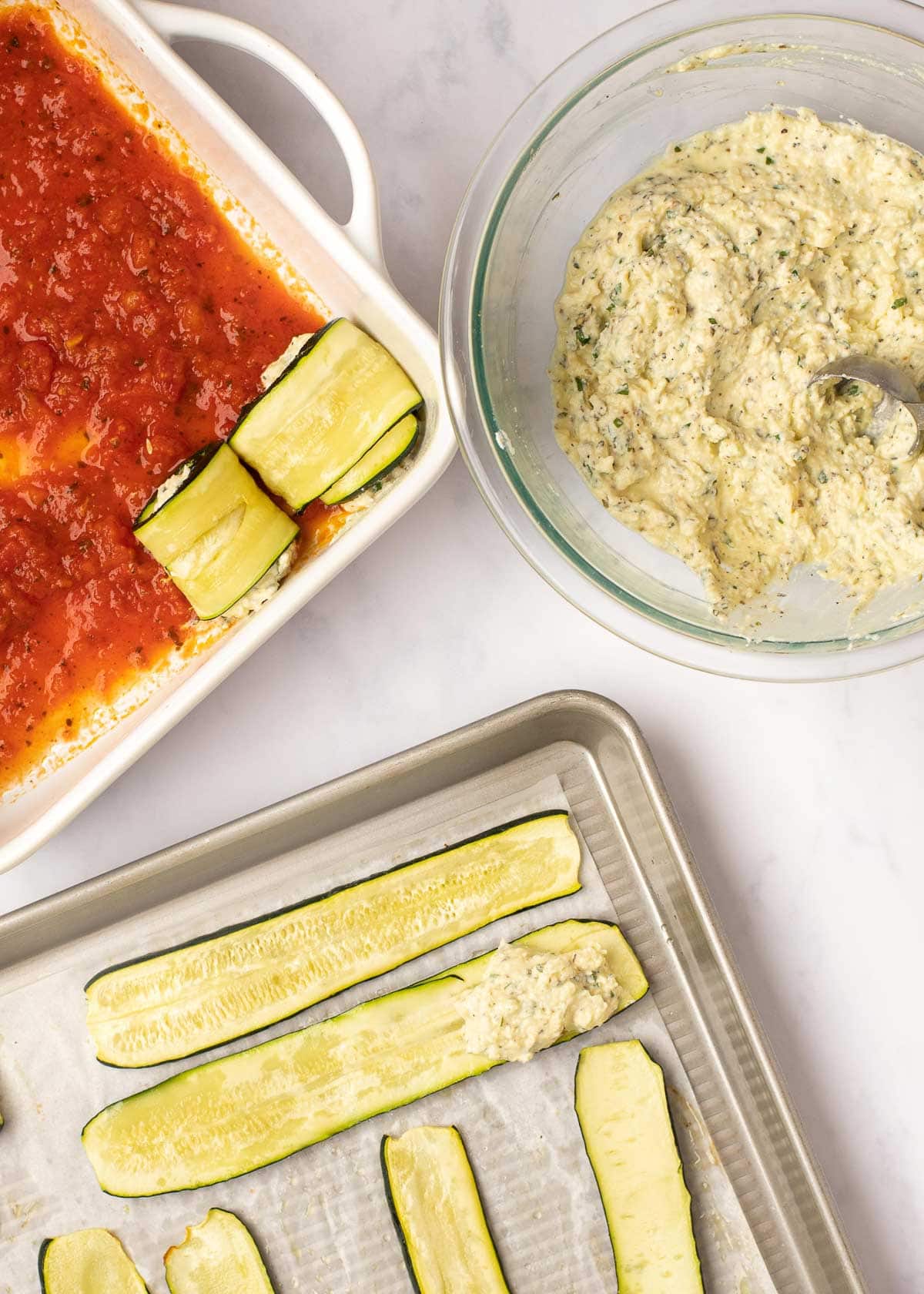 Place no more than 1 tablespoon of cheese filling on each zucchini slice, then roll. These will be placed in a pan coated with marinara sauce.