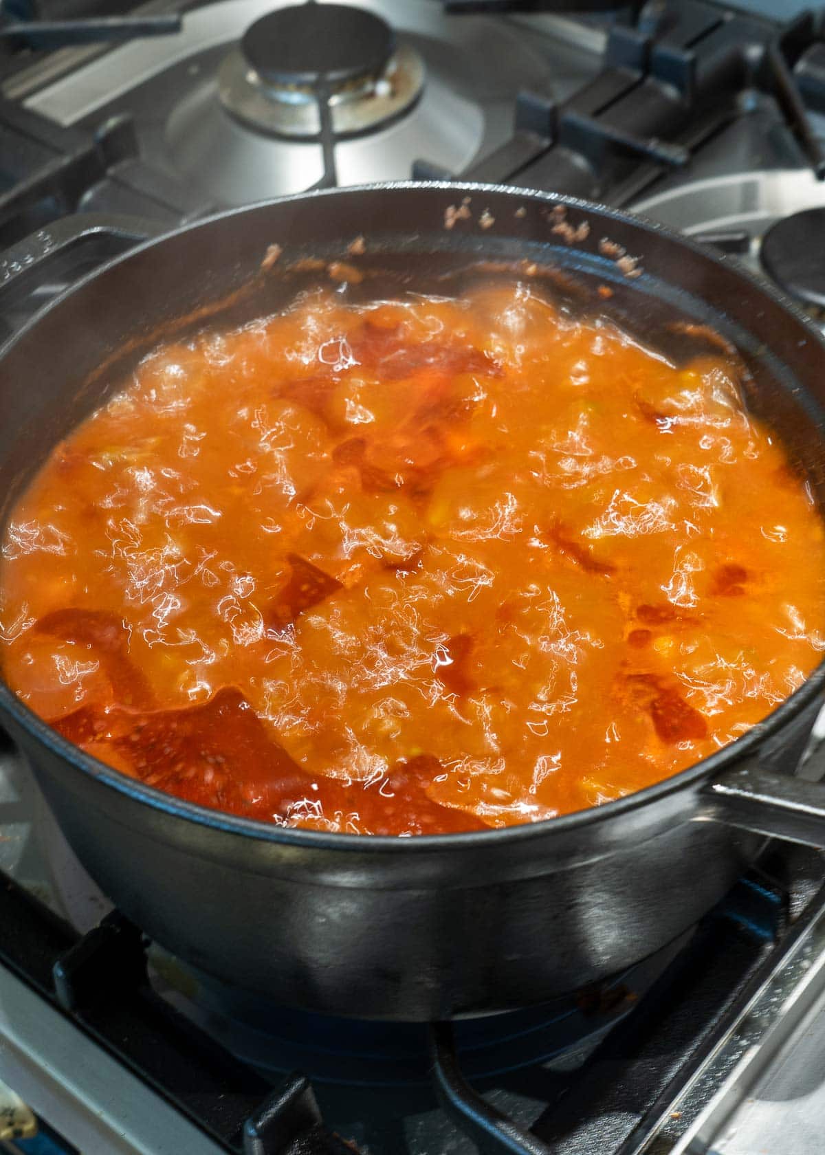 soup simmering in a cast iron dutch oven on the stove