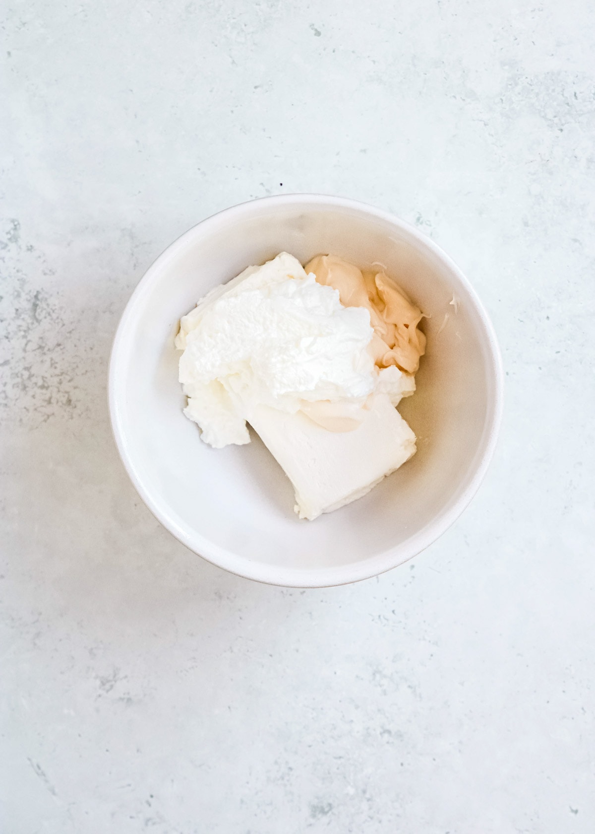 cream cheese, mayonnaise, and greek yogurt in a white bowl