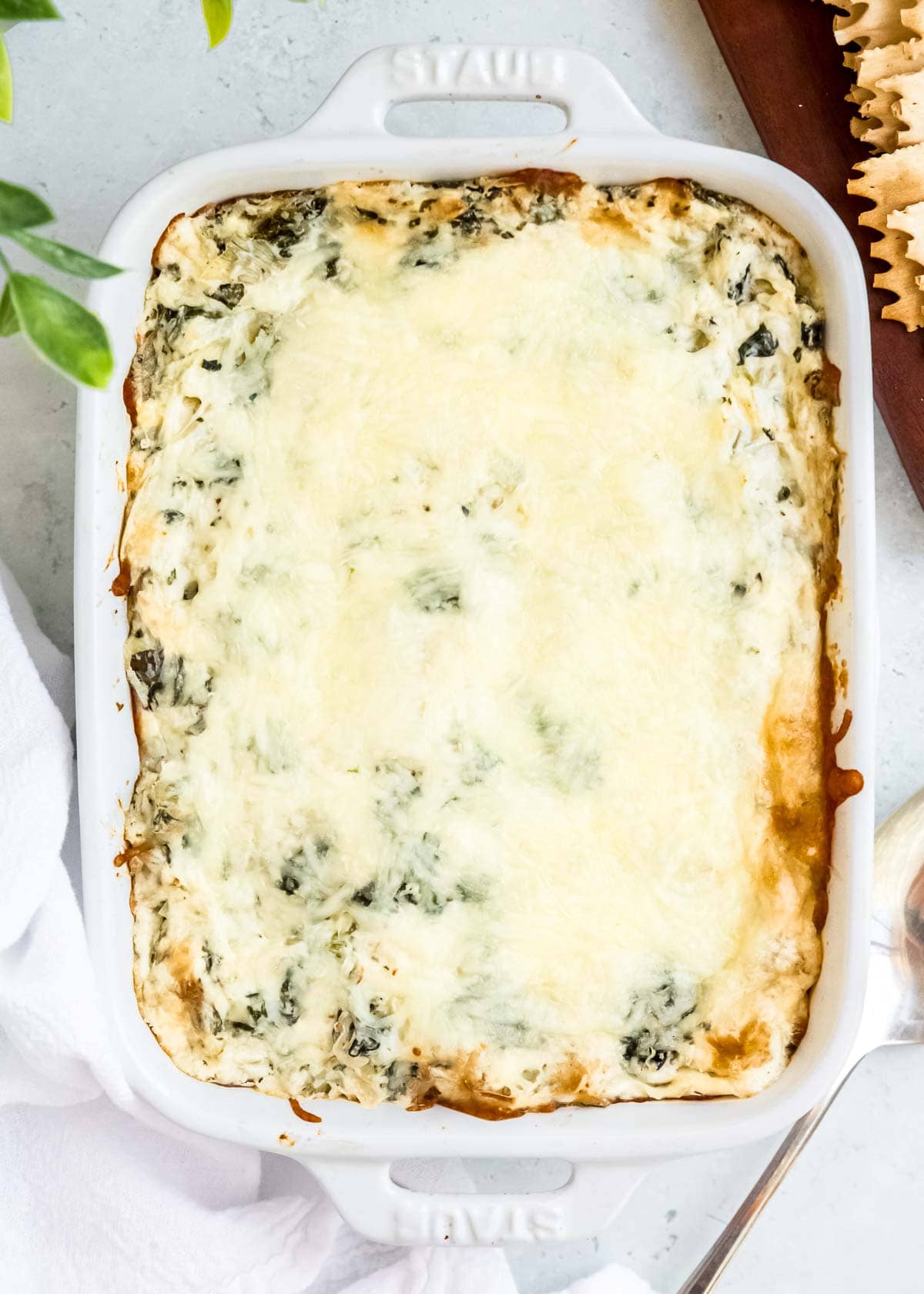 baked spinach artichoke dip in a white dish