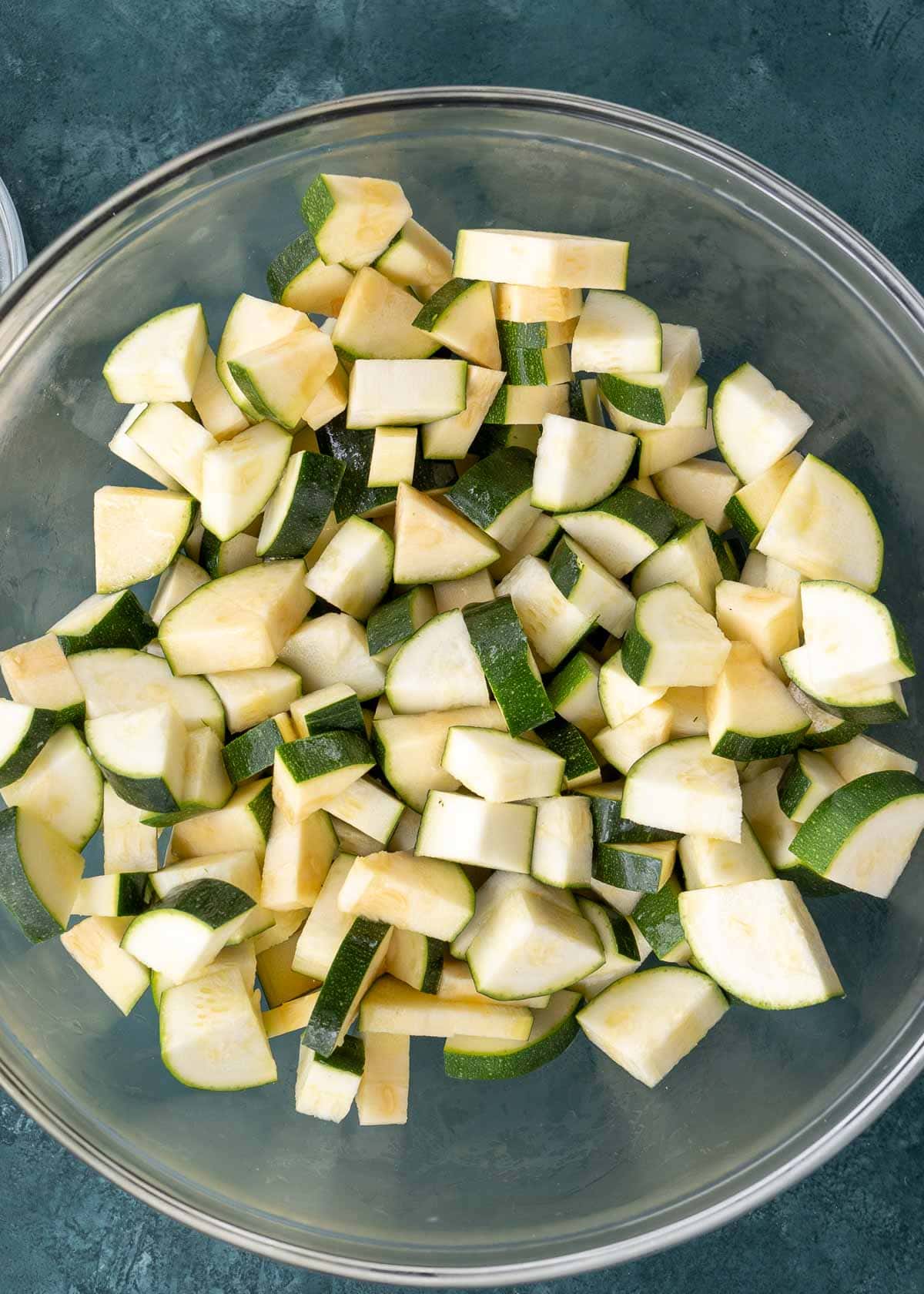 zucchini chopped into small quarters in a glass bowl