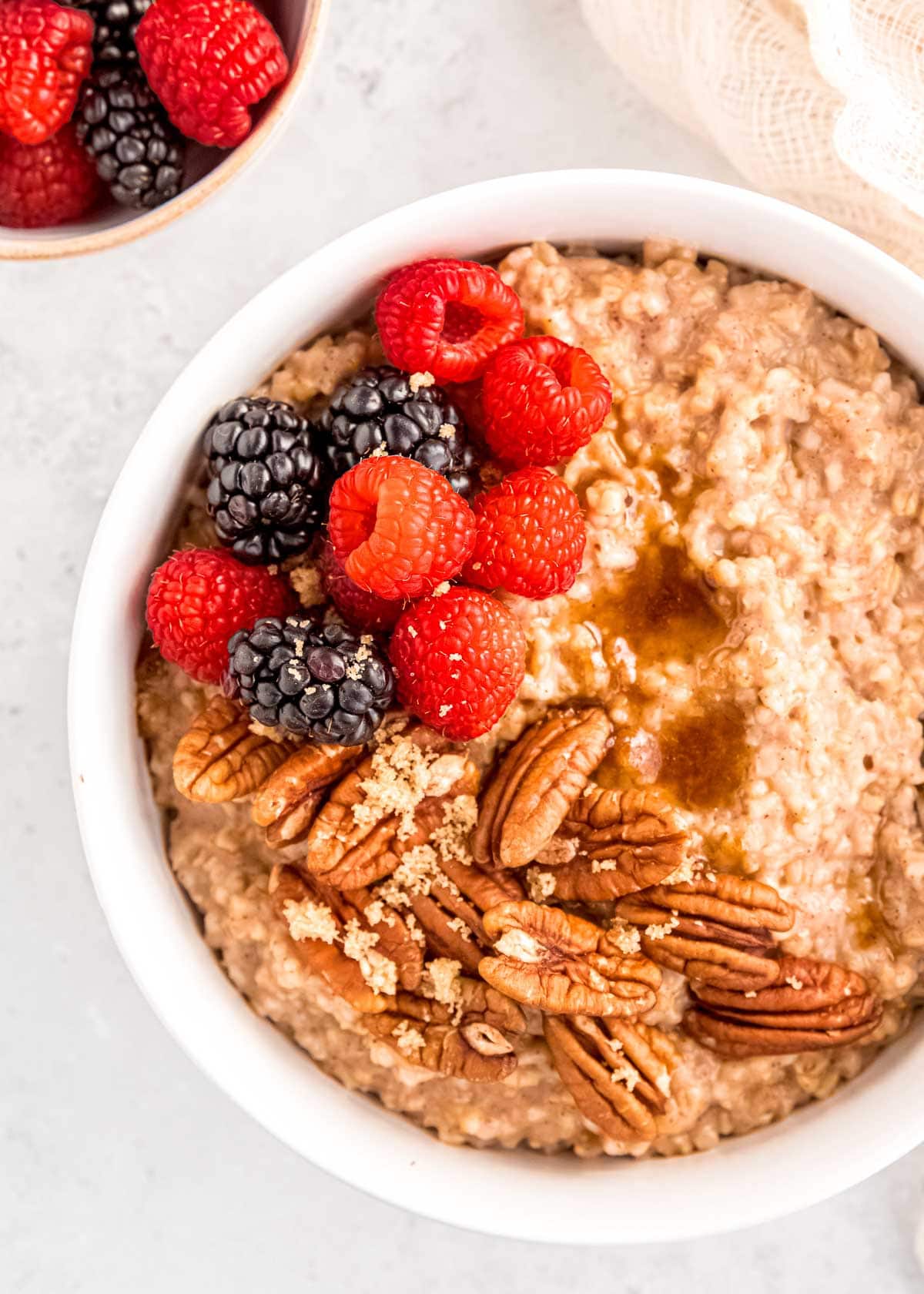 bowl of steel cut oats with pecans and fruit