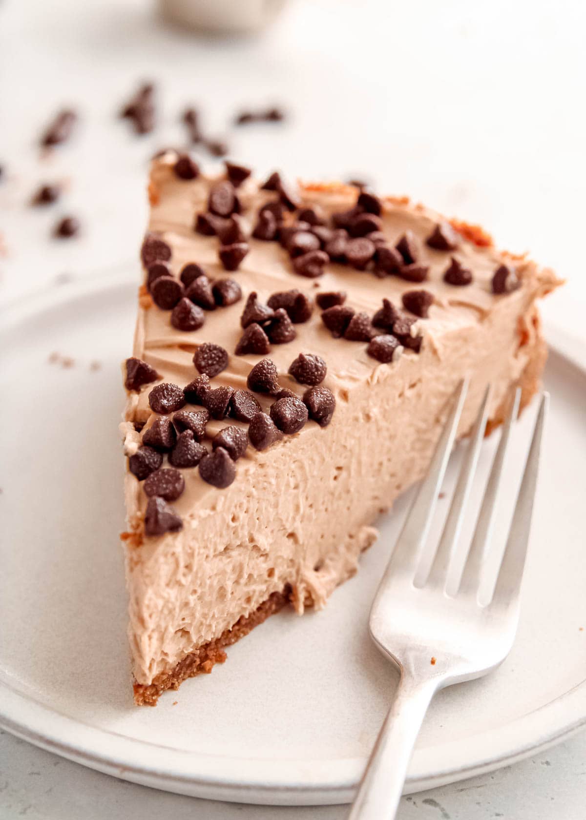 a plate topped with a mocha cheesecake slice and a fork