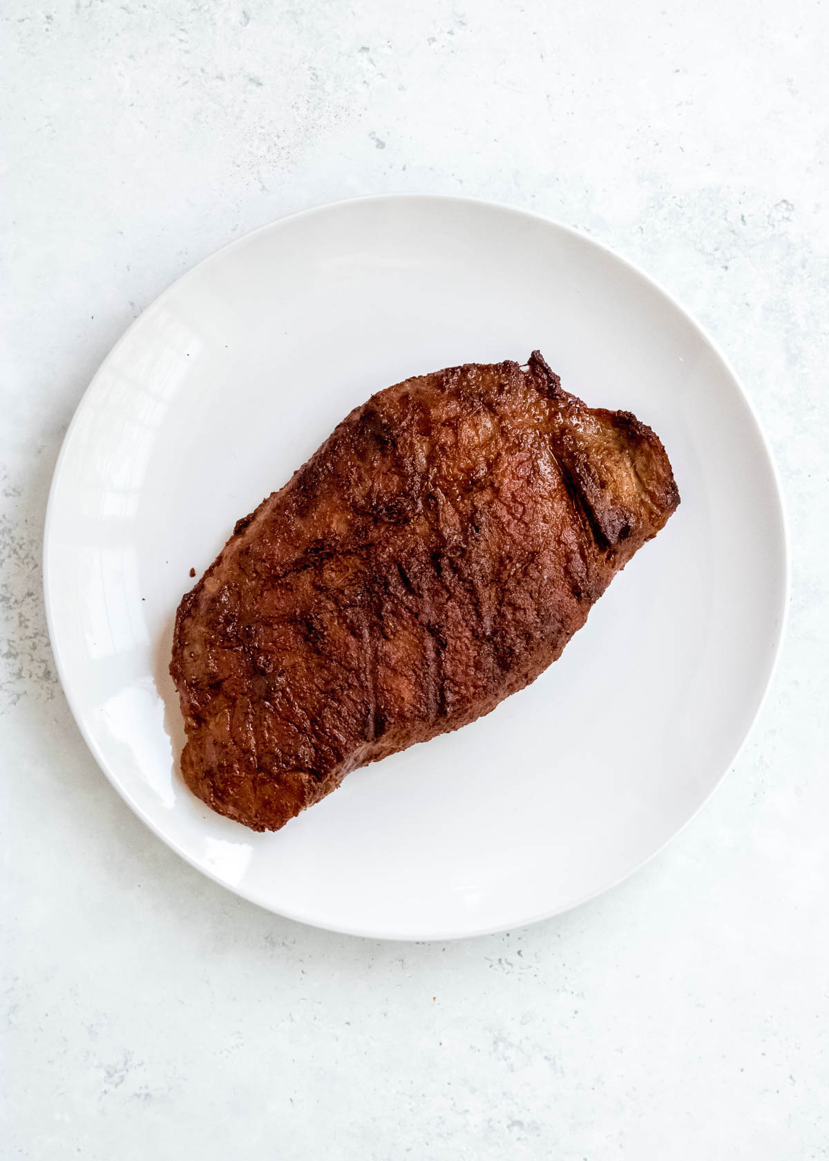 cooked steak on white plate