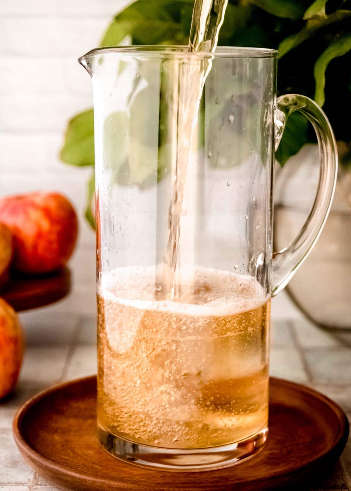 apple cider in pitcher, pour shot